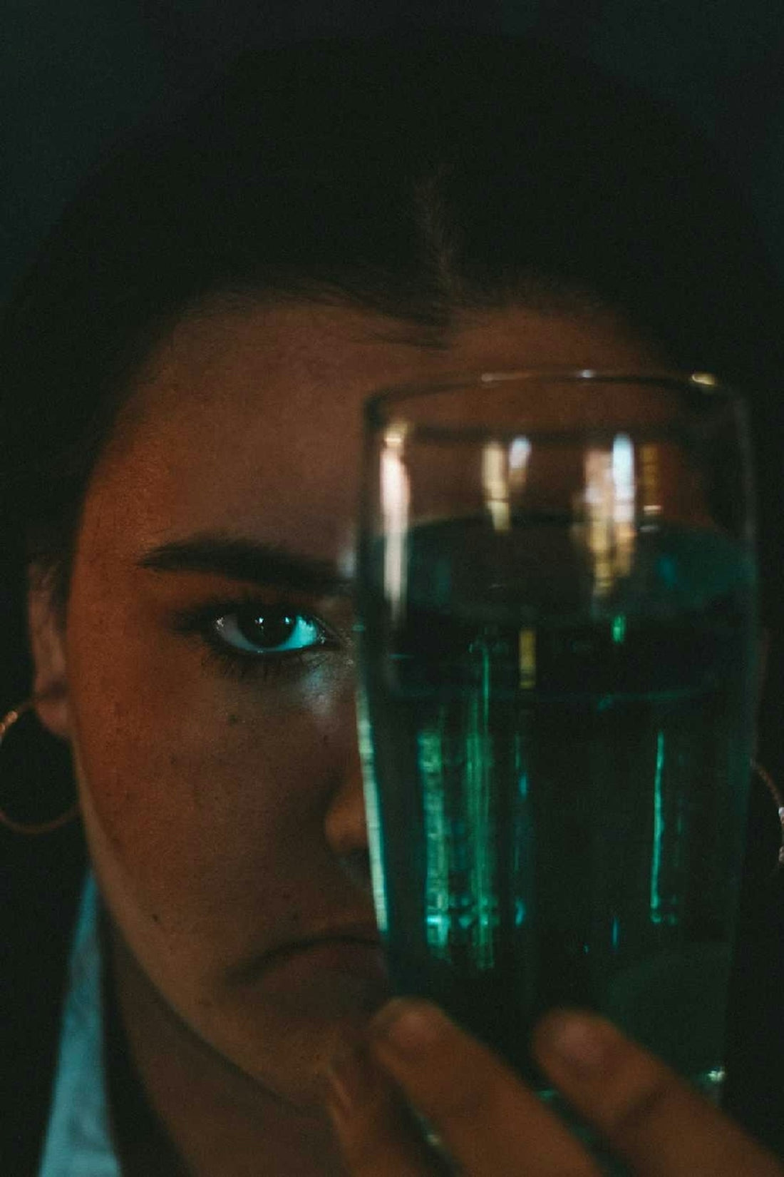 woman holding clear drinking glass